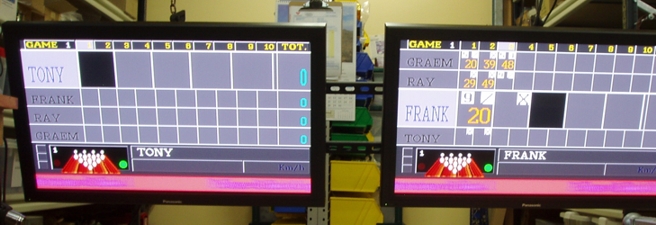 Photo - a pair of flat screen monitors with bowlers score grids