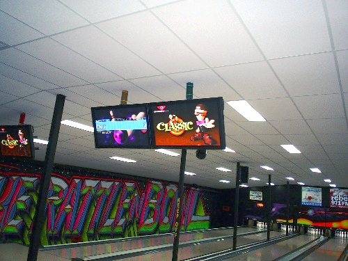 Photo - flat screen monitors installed above bowling lanes